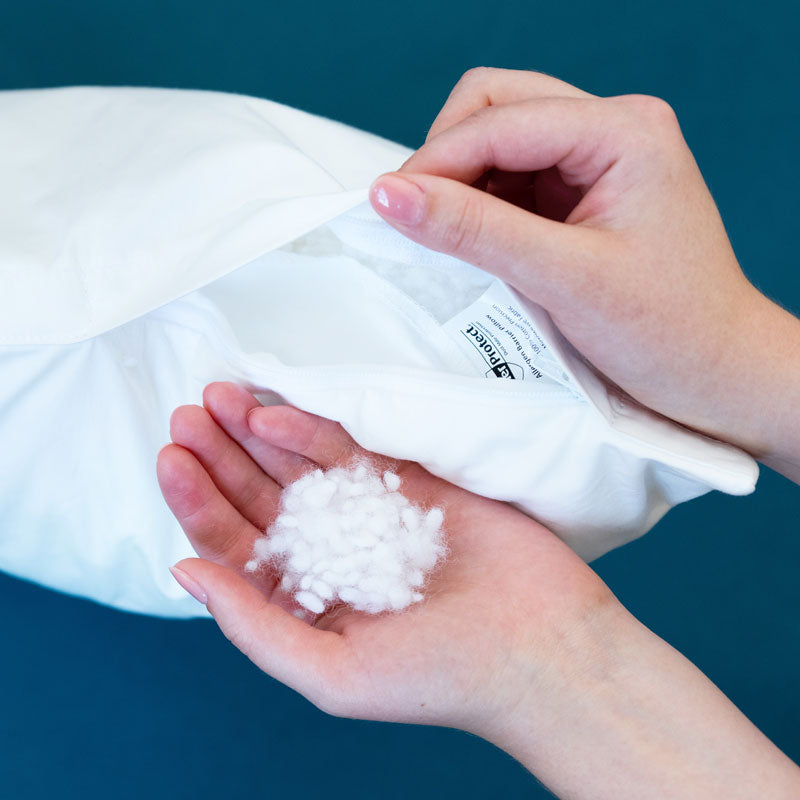 AllerProtect  pillow & cushion filling - fluffy hypoallergenic polyester balls sitting in  a persons hand