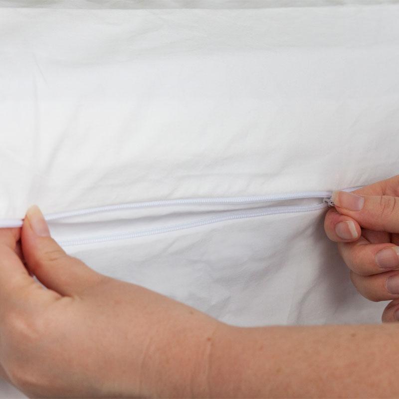Zipping the MiteGuard mattress cover closed to ptorect from dust mite allergen