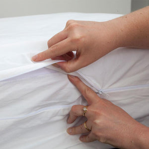 Detail showing how to place the flap under the sip of the MiteGuard mattress cover to protect from dust mites